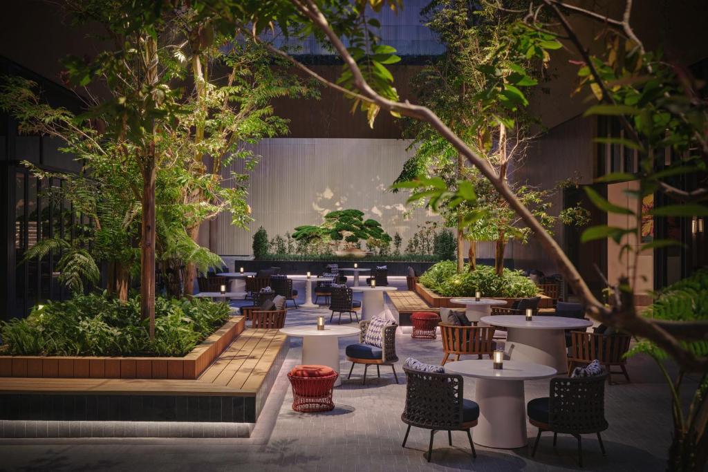 An evening garden dining area surrounds a planted courtyard.
