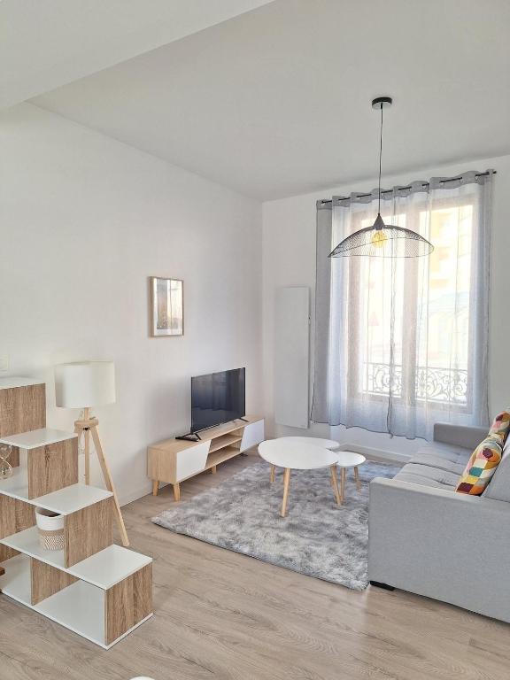a living room with a couch and a table at AquaLodge Vitalia in Aix-les-Bains