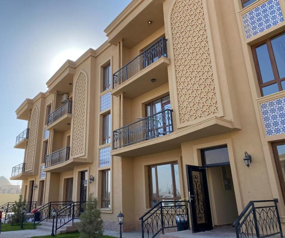 a building with balconies on the side of it at Keruen Saray Apartaments 1 in Türkistan