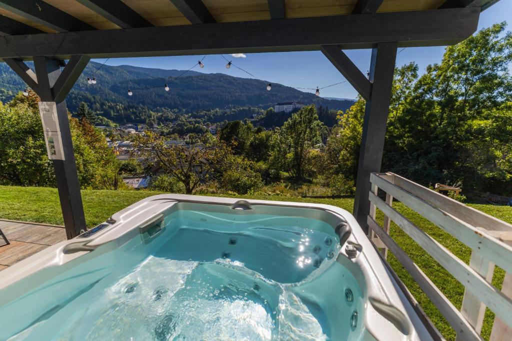a hot tub on the deck of a house at Skier‘s Lodge - Best View in Town! in Sankt Egidi