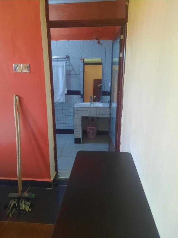 a view of a bathroom with a sink and a mirror at Cobbs in Nanyuki