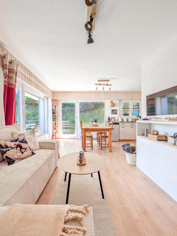 a living room with a couch and a table at Cosy Centered with Garden and View in Veysonnaz in Veysonnaz