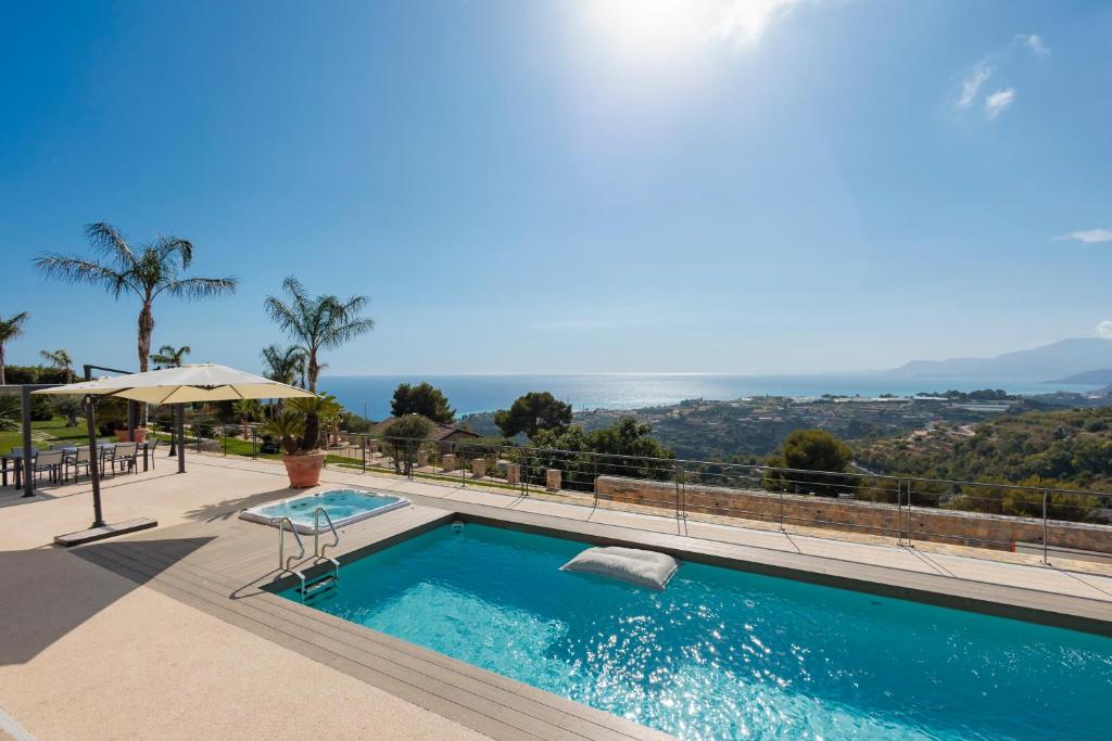 a swimming pool with a view of the ocean at Villa Chloé in Bordighera