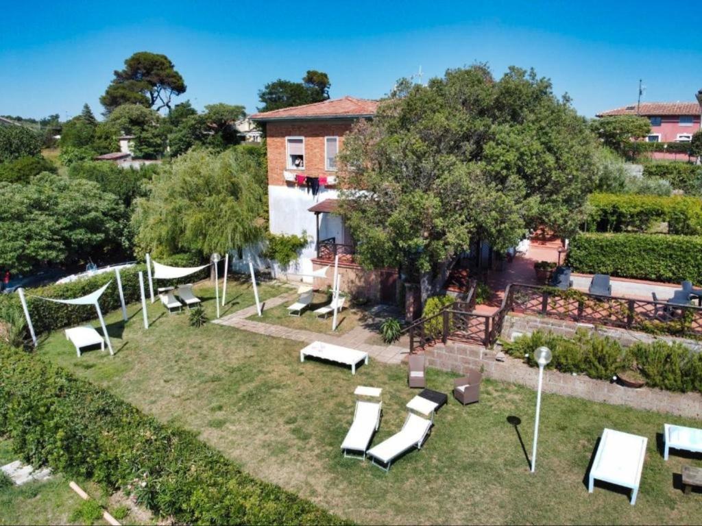 a group of white lounge chairs in a yard at Piccolo Paradiso - Montenero in Montenero