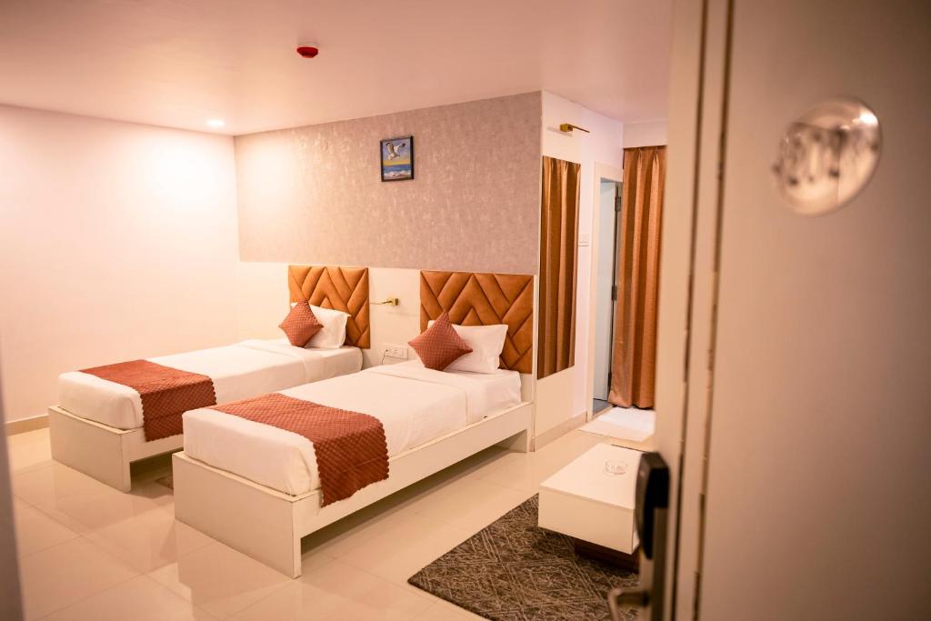 Postel nebo postele na pokoji v ubytování Hotel Atithi