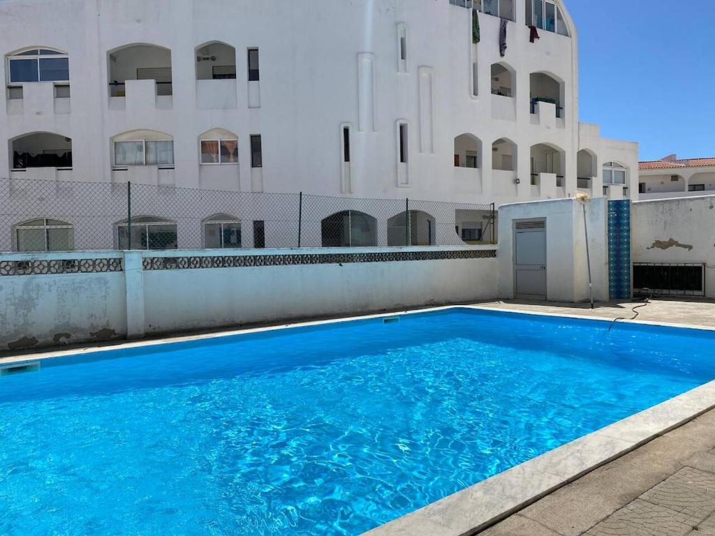 a swimming pool in front of a building at Maryland Terrace by RPG Properties in Albufeira
