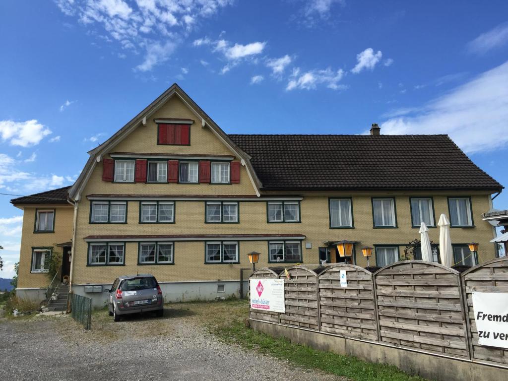 a house with a car parked in front of it at Wohlfühloase für Mensch und Hund in Uzwil