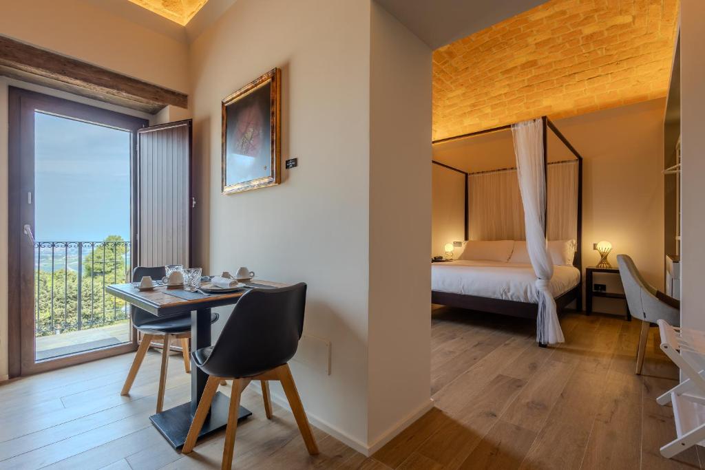 a room with a table and a bed and a window at Montepagano 1137 in Montepagano