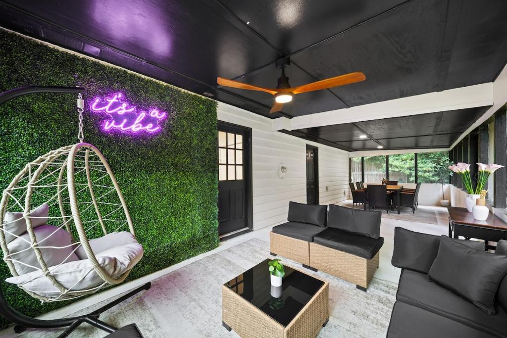 a living room with a green wall with a swing at The Hidden Oasis! Minutes to dwntwn and ATL airpt! in Jonesboro