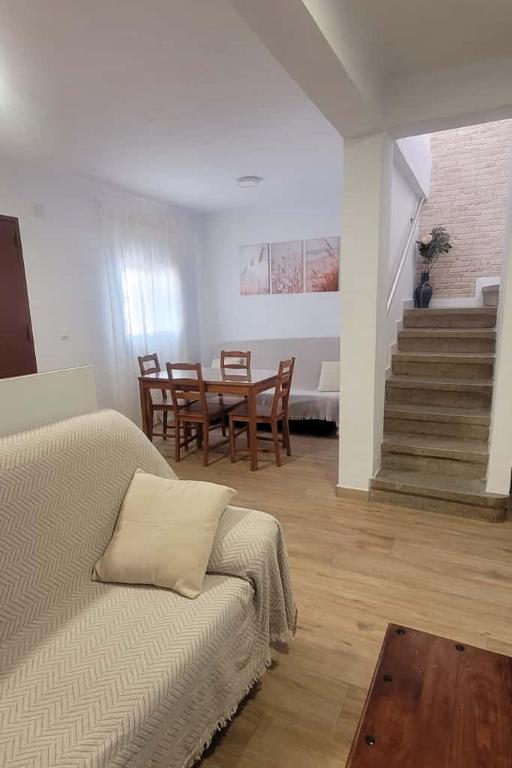 a living room with a bed and a table and chairs at Casa La Retama in La Barca de la Florida