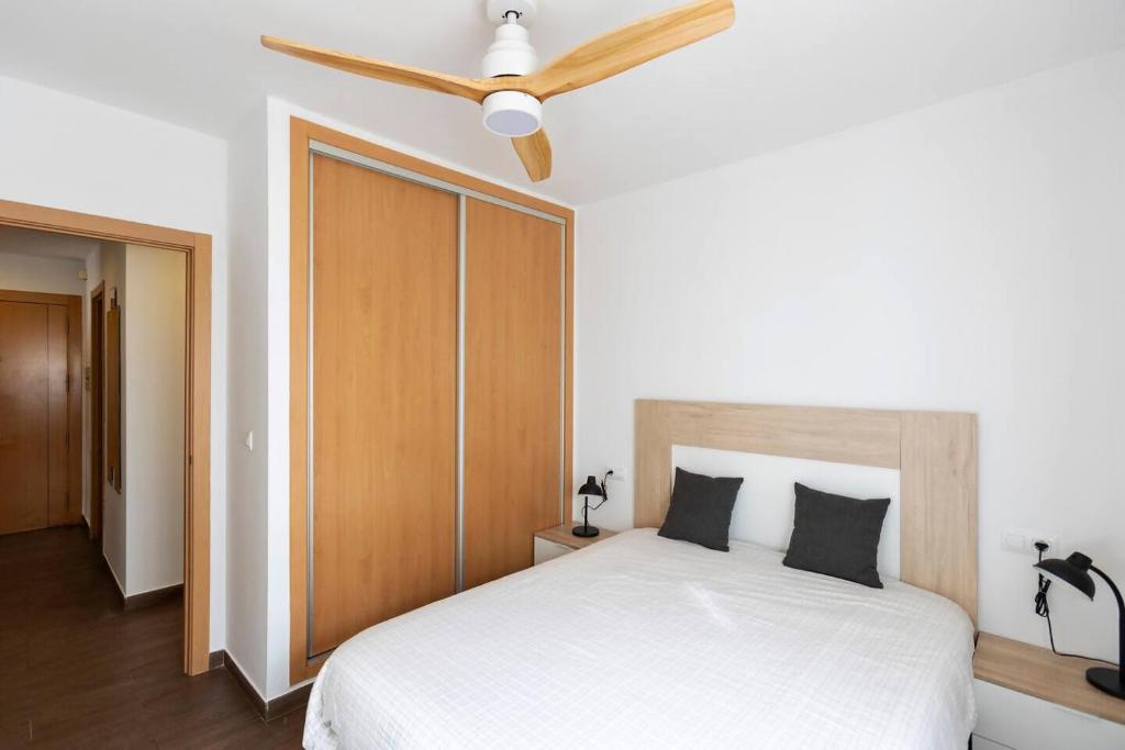 una camera con letto bianco e ventilatore a soffitto di house villa Salobreña a Salobreña