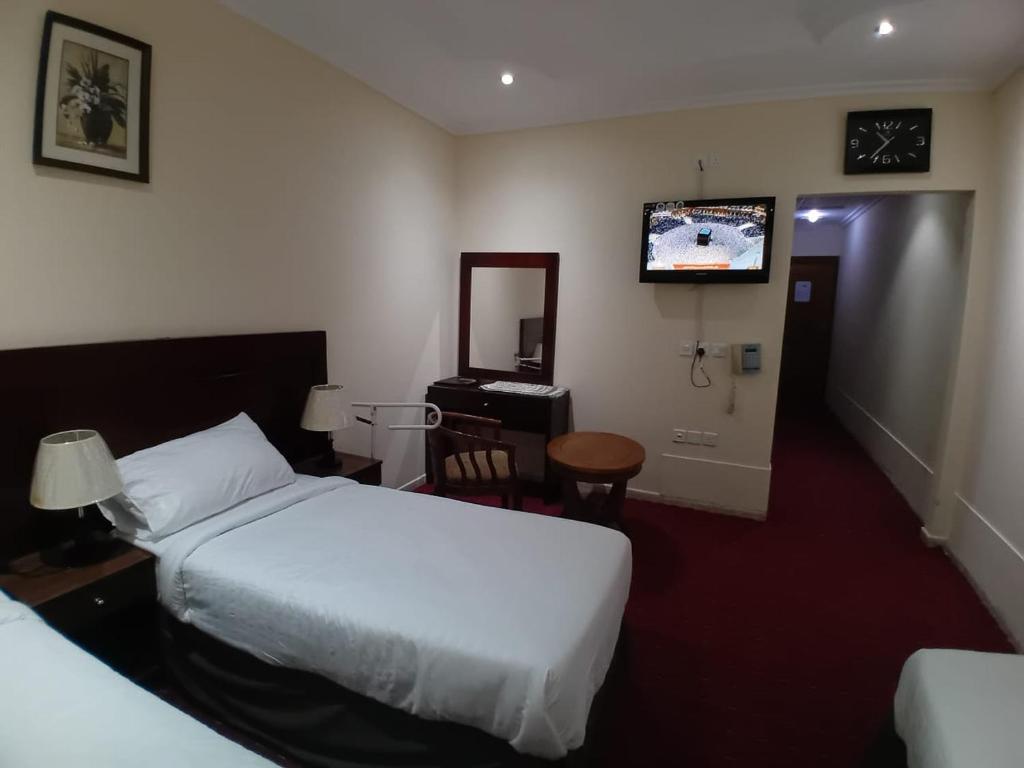 Postel nebo postele na pokoji v ubytování JOHRA MESSAT Hotel