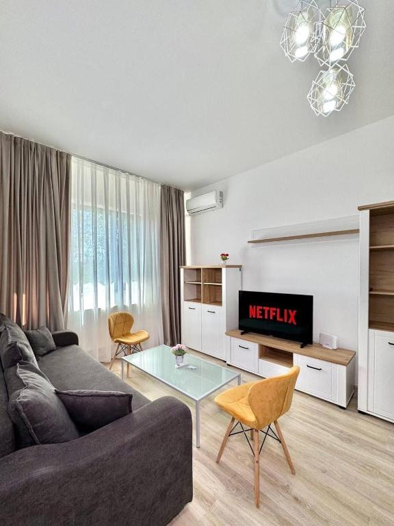 a living room with a couch and a tv at IN APART HOTEL in Bucharest
