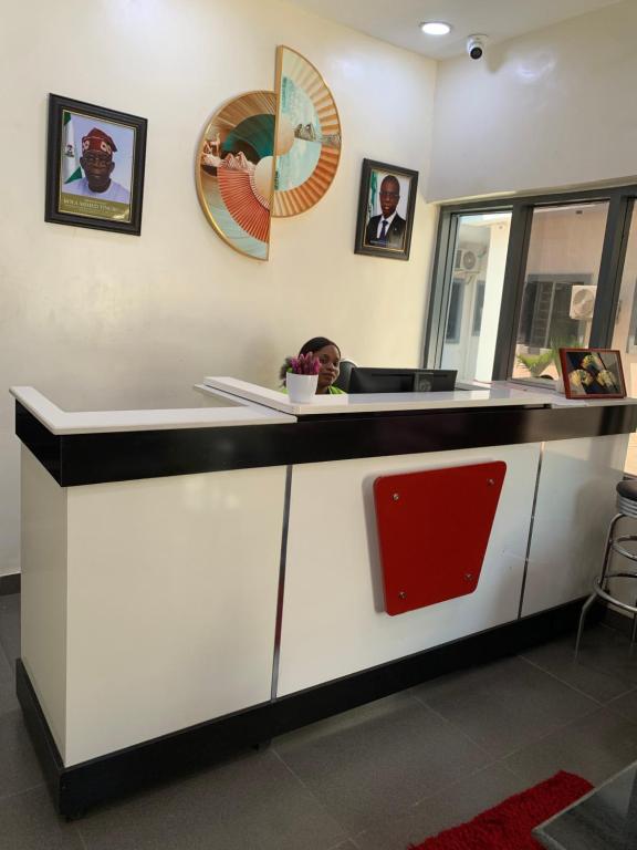 a man sitting at a counter in a restaurant at SATELLITE APARTMENT The Classic Studio 6 in Aiyetoto-Asogun