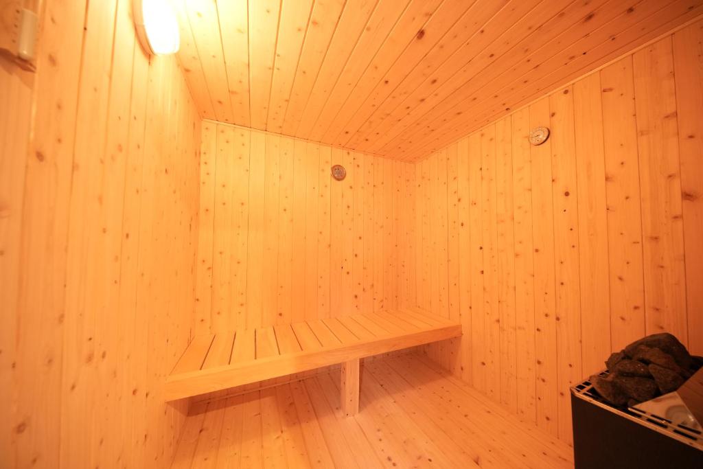 a wooden sauna with a bench in a room at Awaji Nature Retreat in Awaji