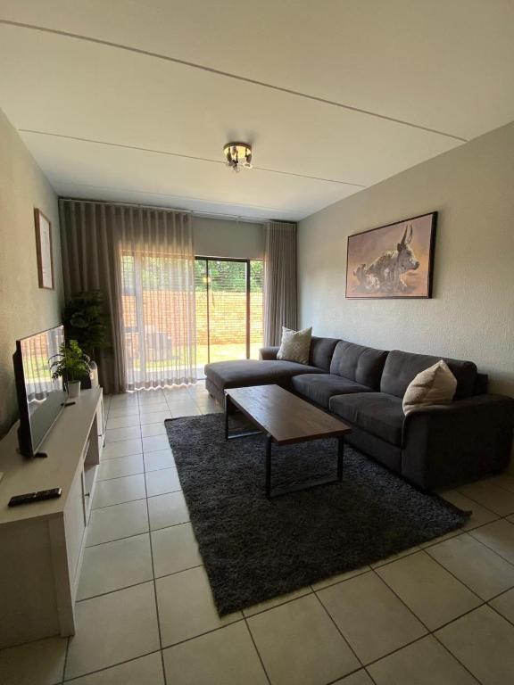 a living room with a couch and a coffee table at Yanaz Place in Germiston