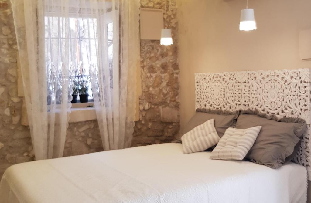 a bed with two pillows in a room with a window at Ortigia SÈFER in Syracuse