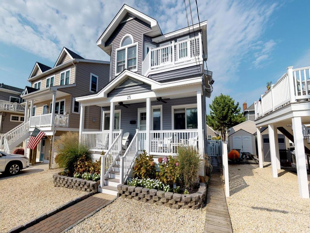 a large house with white railings on a street at Wifi Decks Private Yard Beach Badges Beach Chairs Keurig Os Wd 3Rd Off The Beach in Brant Beach