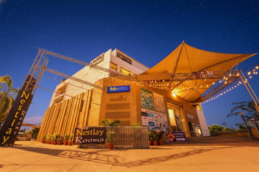 a large building with lights in front of it at Oriva Nestlay Rooms Ramnad - Nr Golden Shopping Mall in Rāmanāthapuram