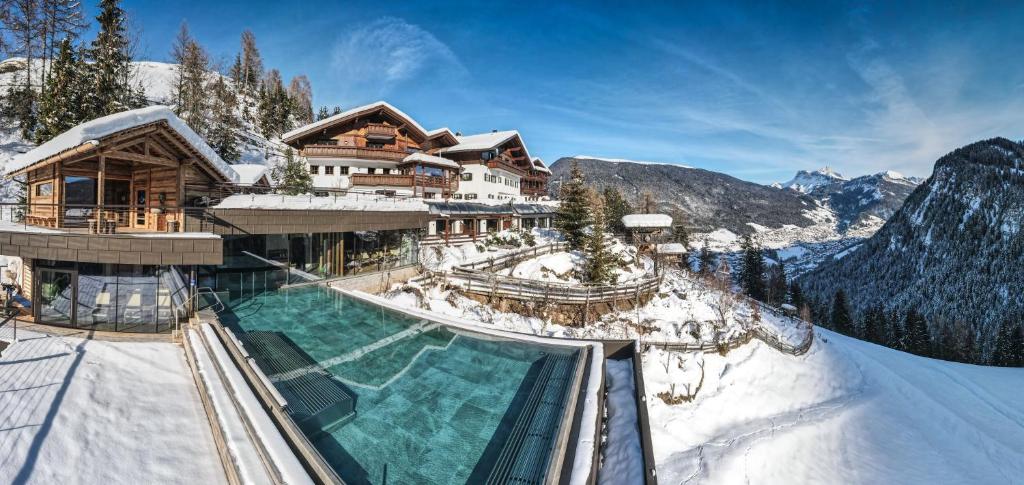 an aerial view of a resort in the snow at Charmehotel Uhrerhof - Deur in Ortisei