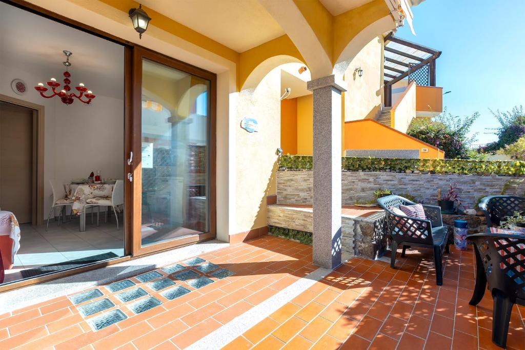 a patio with glass doors and a table and chairs at Petra Maris in Castelsardo
