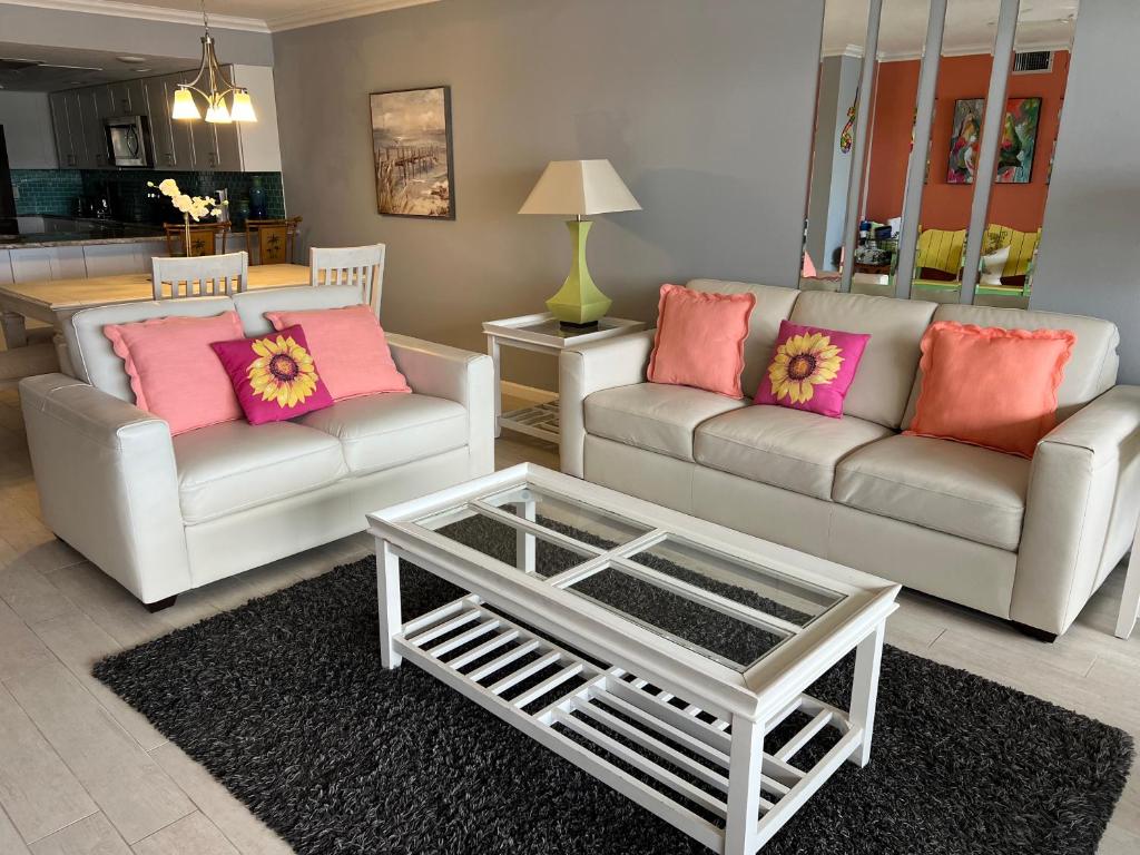 a living room with two couches and a coffee table at Book Me Baby! Bayview Beauty at Siesta Key in Siesta Key