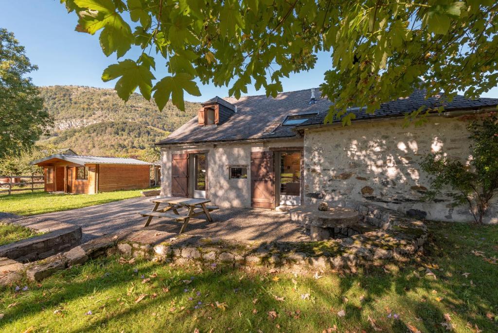 a stone house with a picnic table in front of it at Charmante Bergerie in Castet