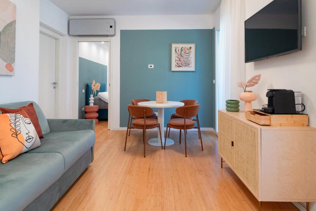 a living room with a couch and a table at Essenza INN Luxury Apartaments in Pescara