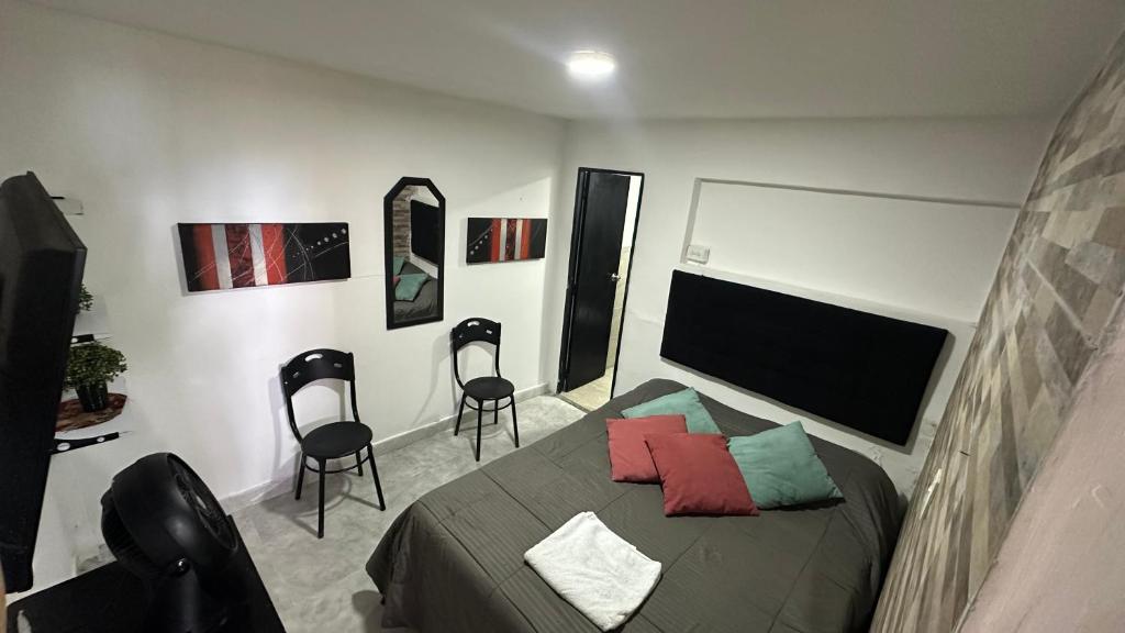 Postel nebo postele na pokoji v ubytování Hostal casa los naranjitos