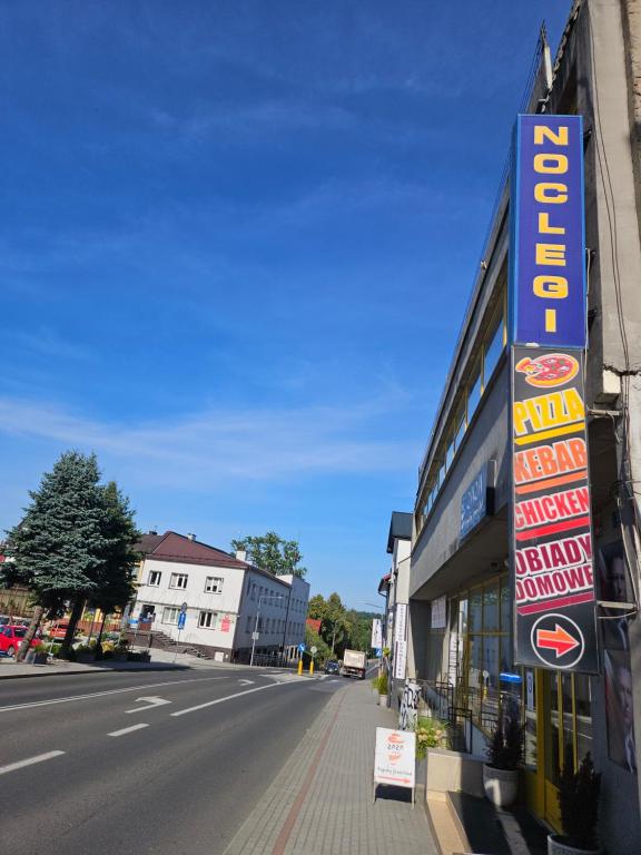 a sign on the side of a building next to a street at Bobowianka in Bobowa