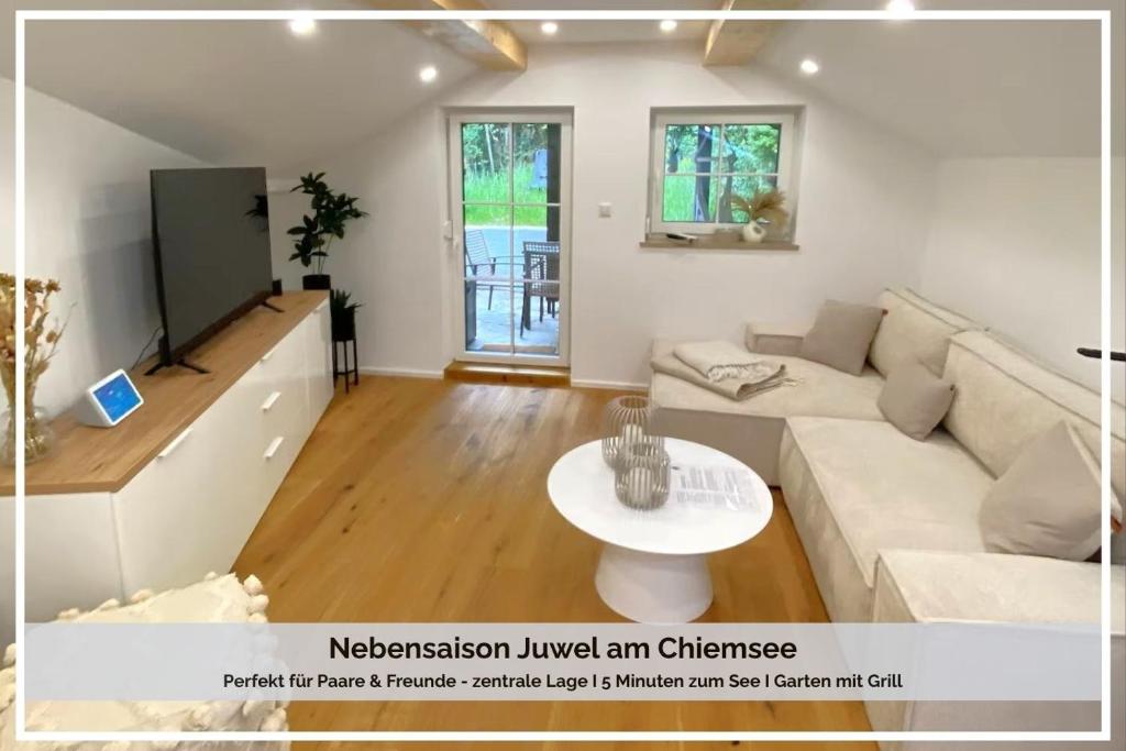 a living room with a couch and a tv at Cozy Alpenloft Chiemsee by Dollop Living in Bernau am Chiemsee
