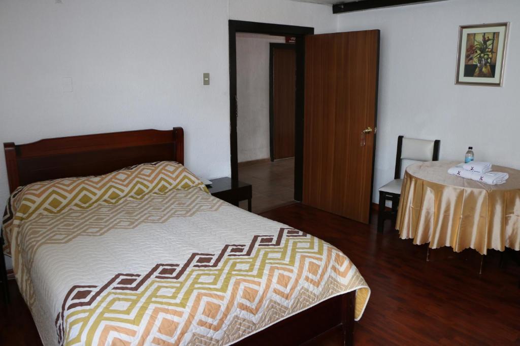 Postel nebo postele na pokoji v ubytování Hotel 6 De Diciembre