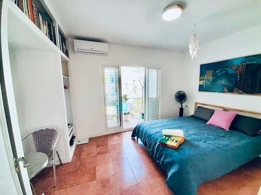 a bedroom with a bed with a blue comforter at Sitges Times Square - Private and Central in Sitges