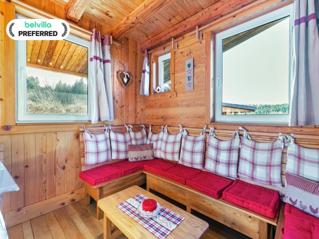 a room with red and white pillows and a table at Chalet in Harreberg with Garden Views in Harreberg