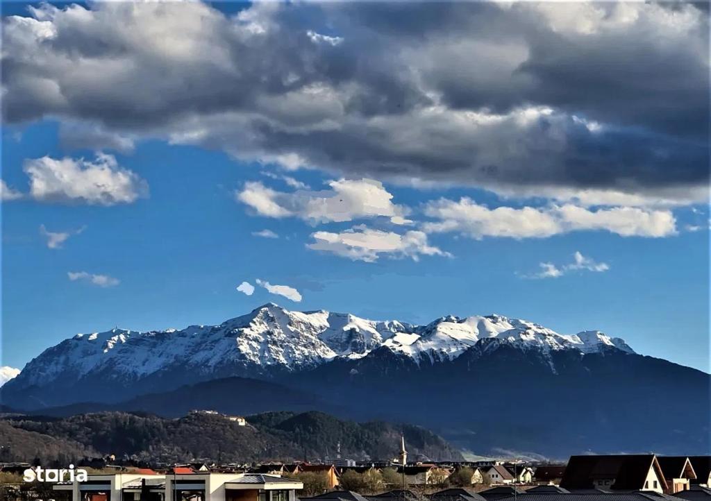 a view of a mountain with snow covered mountains at Penthouse Râșnov 80mp, balcon 30mp in Râşnov