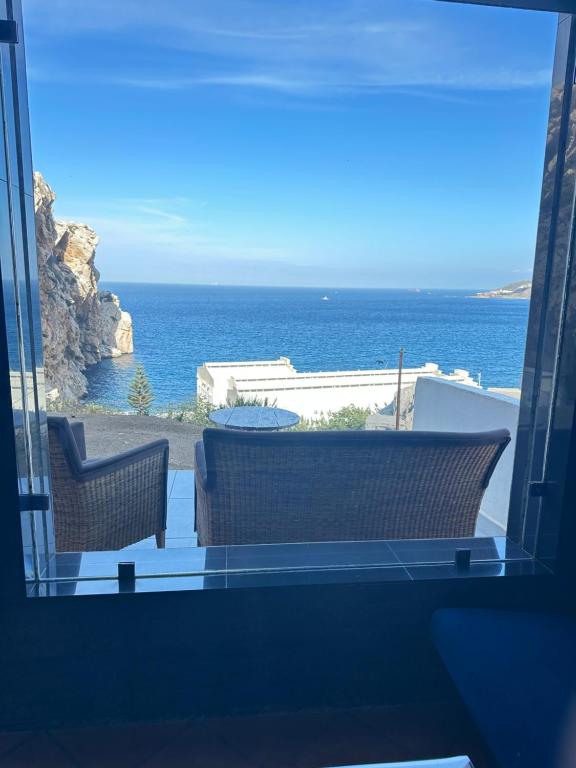 a view of the ocean from the balcony of a house at "Seaside Studio with Stunning Views in Belyounech in Belyounech 