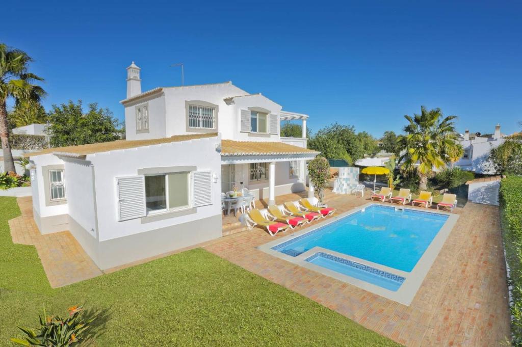 a villa with a swimming pool and a house at Villa Flor by Villa Plus in Guia
