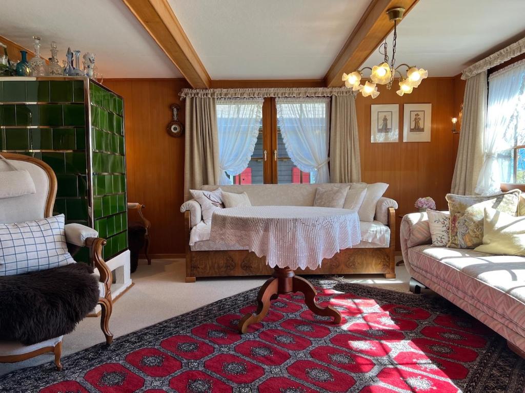 a living room with a couch and a table at Beatli Chalet in Wildhaus