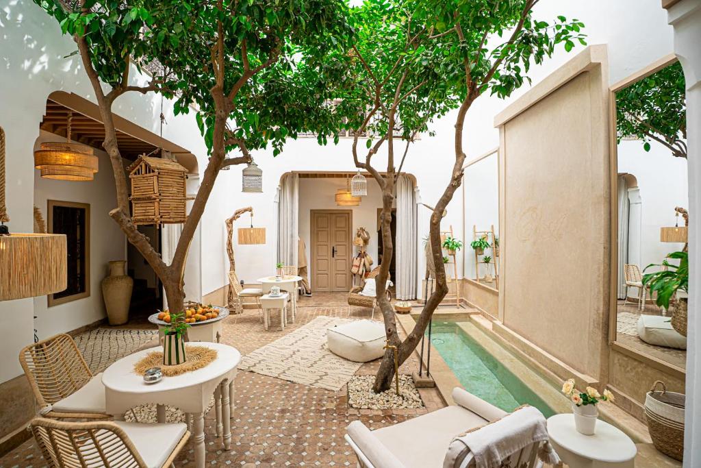 a living room with trees and a pool at Riad Les Orangers D'alilia in Marrakech