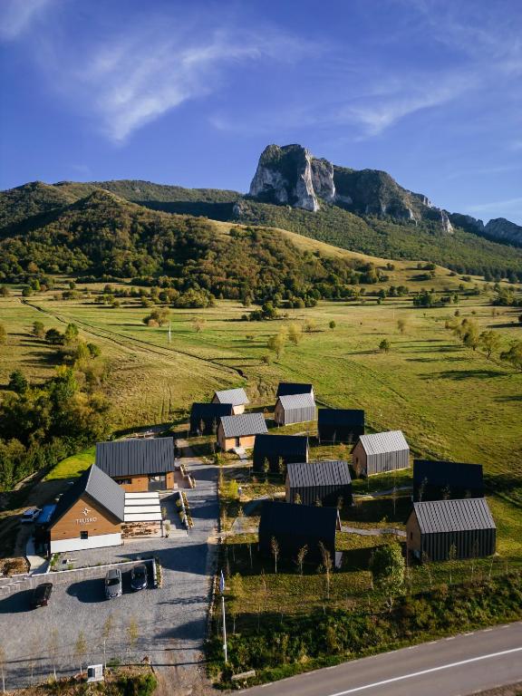an aerial view of a farm with a mountain in the background at Trusko Resort - Small Luxury Hotels of the World in Rimetea