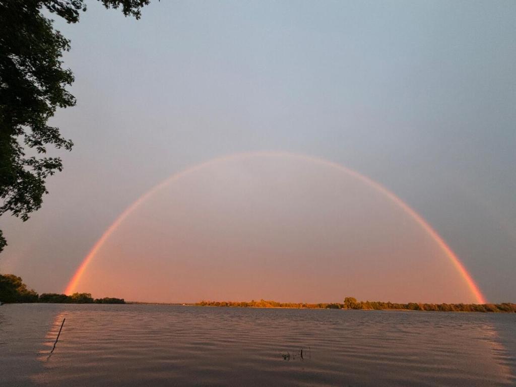 two double rainbow in the sky over a body of water at Tackle Box Retreat in Deseronto