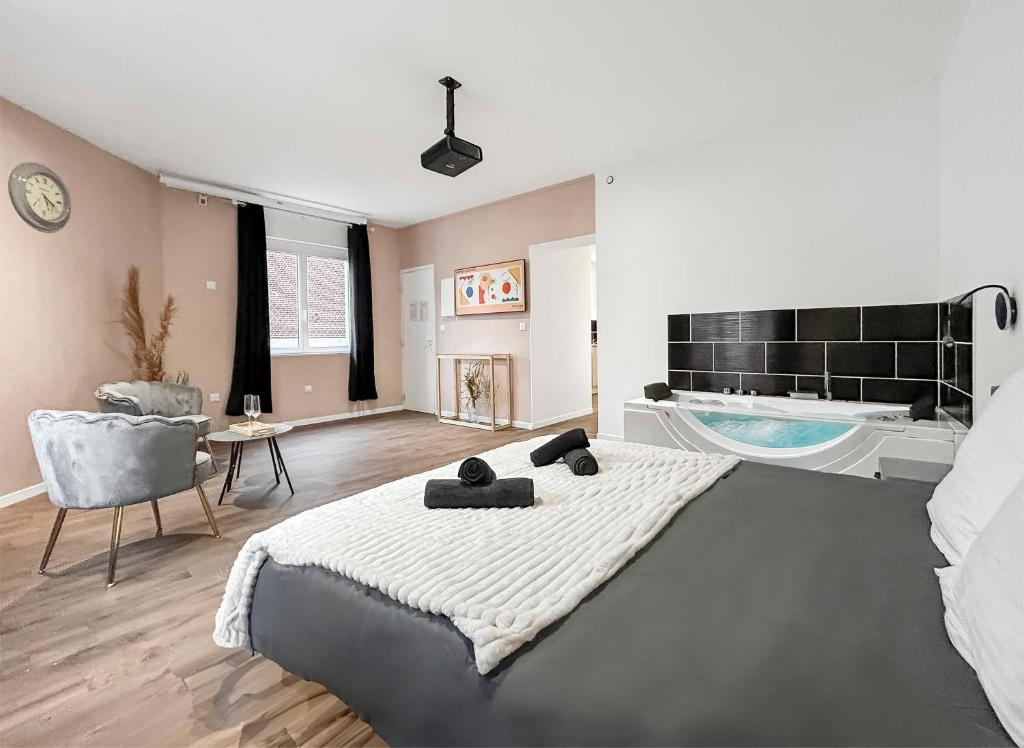 a bedroom with a large bed and a swimming pool at Balnéo privée, Cinéma, Fibre & Patio in Tourcoing
