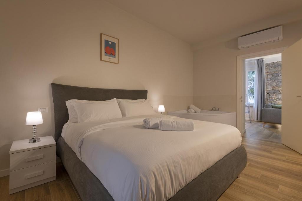 a bedroom with a large white bed and a bathroom at Il Fontanile in Como