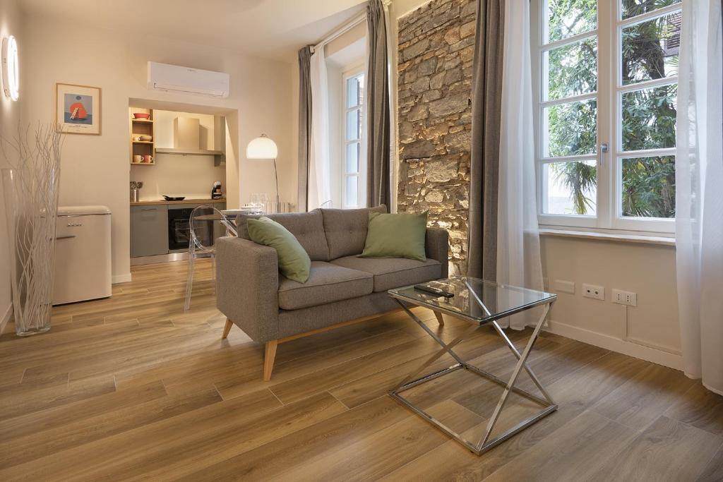 a living room with a couch and a glass table at Il Fontanile in Como