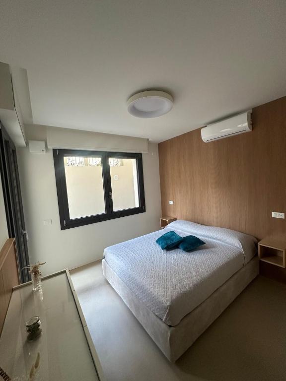 a bedroom with a large bed and a window at Colle del Mare in Gabicce Mare