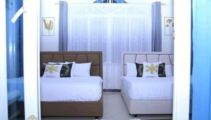 Postel nebo postele na pokoji v ubytování Nyali Beach front Homes