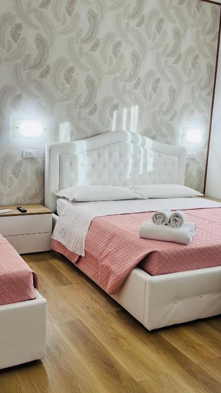 a bedroom with a white bed with two rings on it at Ca Aisha Train Station Venice in Mestre
