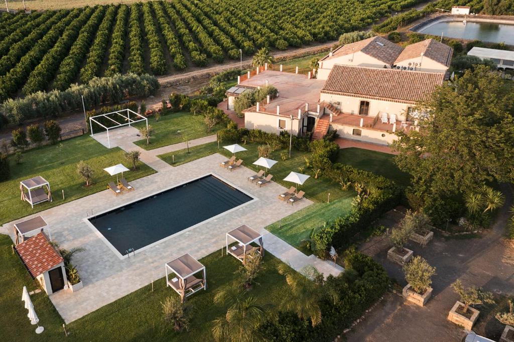 an aerial view of a mansion with a swimming pool and a house at Nèroli Bio Relais in Catania