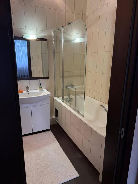 a bathroom with a tub and a sink and a shower at Квартира в центре in Dnipro