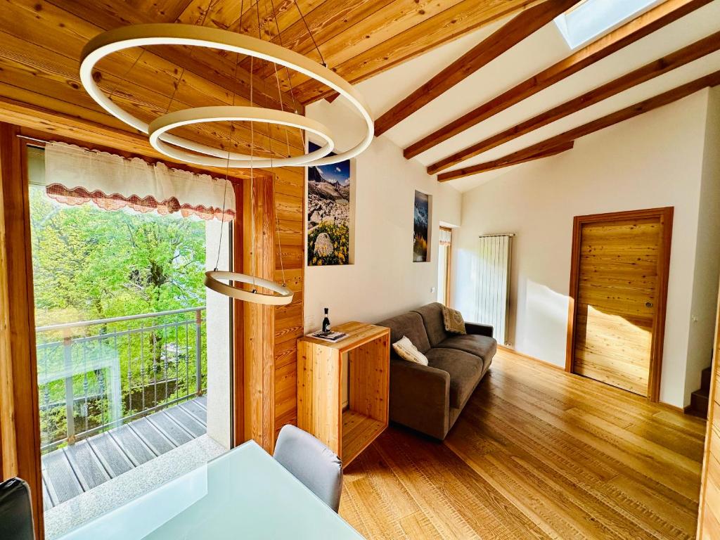 a living room with a couch and a chandelier at Mulini 22 - Eco Suite & Spa in Temù